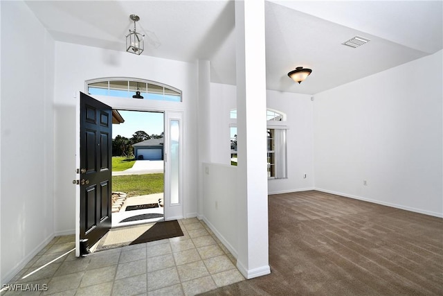 entryway featuring carpet, plenty of natural light, baseboards, and visible vents