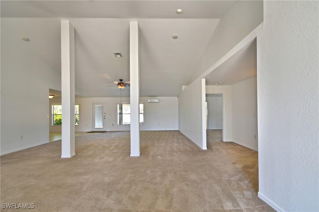 interior space featuring ceiling fan, baseboards, visible vents, and light carpet