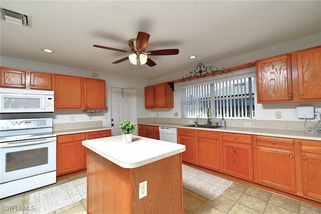 kitchen featuring visible vents, white appliances, light countertops, and a ceiling fan