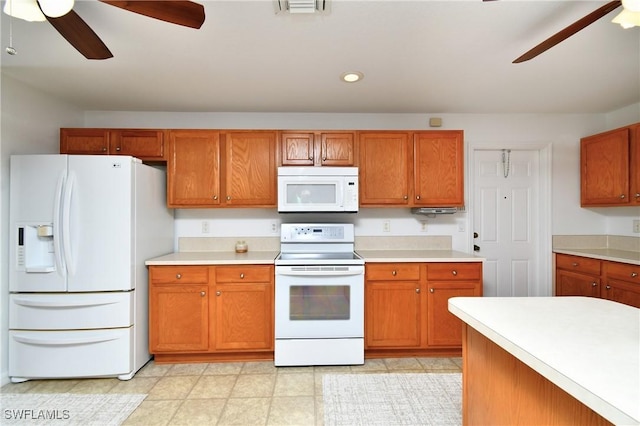 kitchen with white appliances, brown cabinets, a ceiling fan, and light countertops