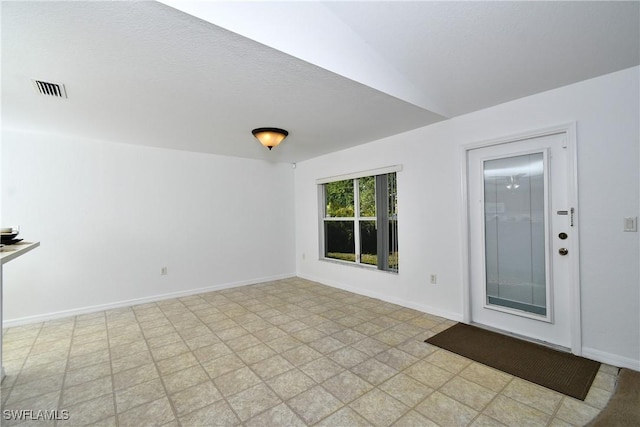 spare room with visible vents and baseboards