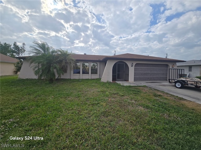 view of front of house featuring stucco siding, a garage, concrete driveway, and a front yard