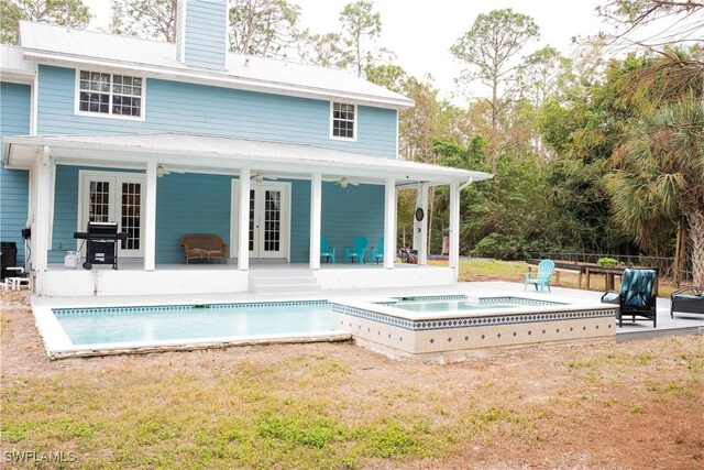 back of house featuring a patio, a ceiling fan, a fenced in pool, a chimney, and french doors