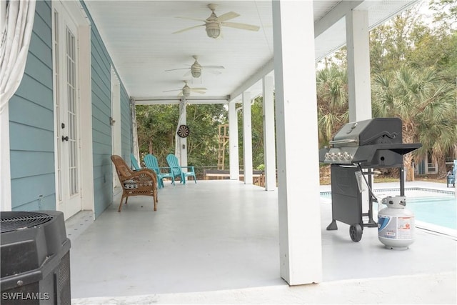 view of patio / terrace with a ceiling fan, heating unit, covered porch, a grill, and an outdoor pool