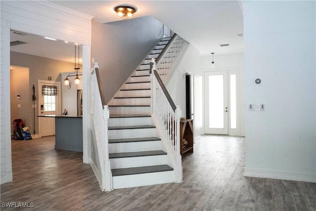 stairway featuring baseboards and wood finished floors