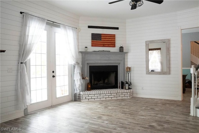 unfurnished living room with plenty of natural light, french doors, and wood finished floors