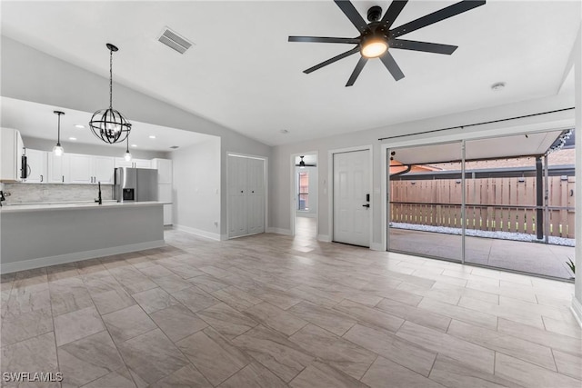 unfurnished living room with visible vents, baseboards, lofted ceiling, recessed lighting, and ceiling fan with notable chandelier