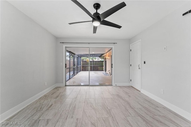 unfurnished room featuring a ceiling fan and baseboards