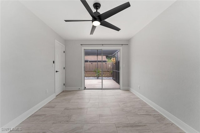 empty room featuring baseboards and ceiling fan