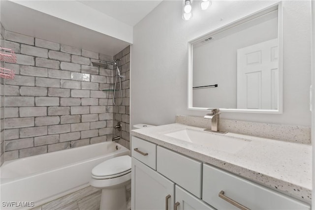 bathroom featuring toilet, vanity, bathing tub / shower combination, and wood finished floors