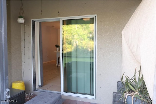 entrance to property with stucco siding