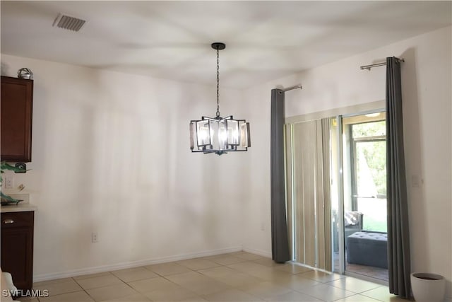 unfurnished dining area with a notable chandelier, visible vents, and baseboards