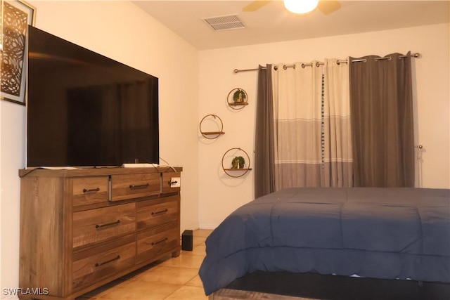 bedroom with ceiling fan, visible vents, and light tile patterned flooring