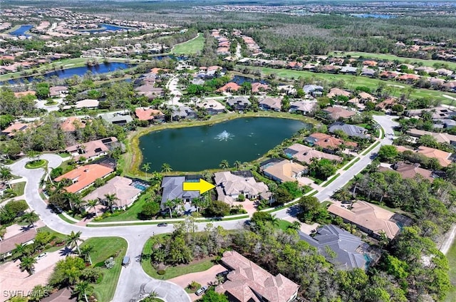 drone / aerial view with a residential view and a water view