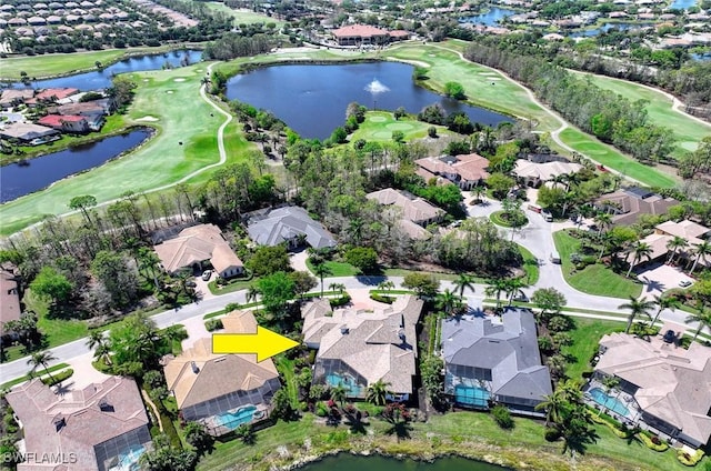 aerial view with a residential view, golf course view, and a water view