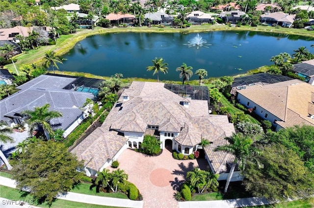 drone / aerial view featuring a water view and a residential view