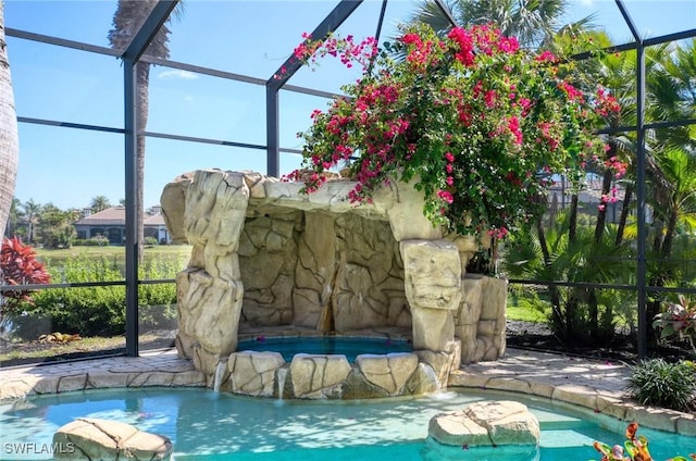 pool with a lanai and a patio