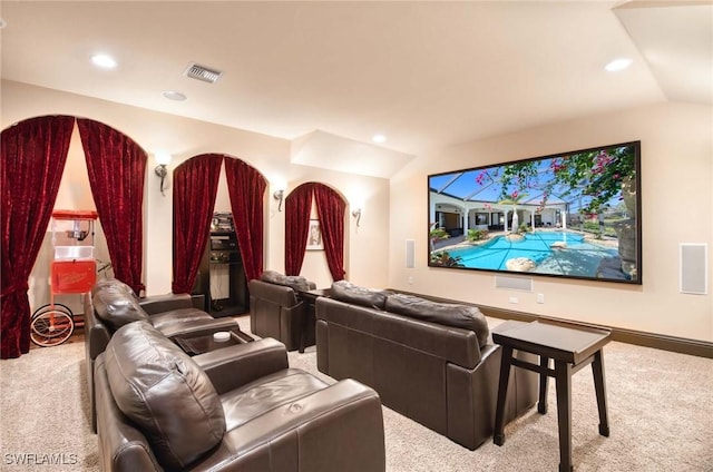 cinema room with visible vents, recessed lighting, lofted ceiling, and carpet floors