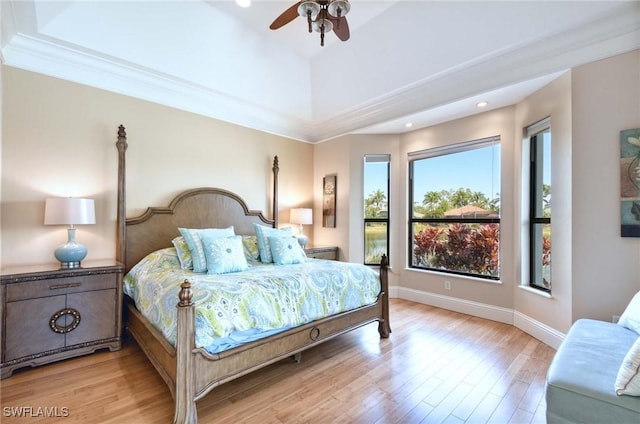 bedroom with light wood finished floors, ceiling fan, and baseboards