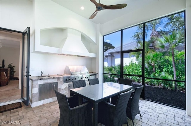 sunroom / solarium with a sink and ceiling fan