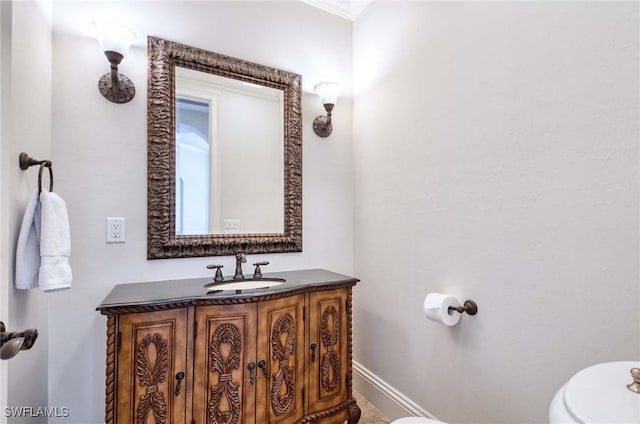 half bathroom with baseboards, toilet, and vanity