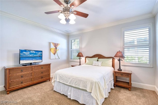 carpeted bedroom featuring crown molding, multiple windows, a ceiling fan, and baseboards