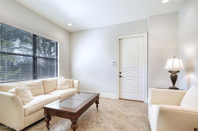 living room featuring recessed lighting and baseboards