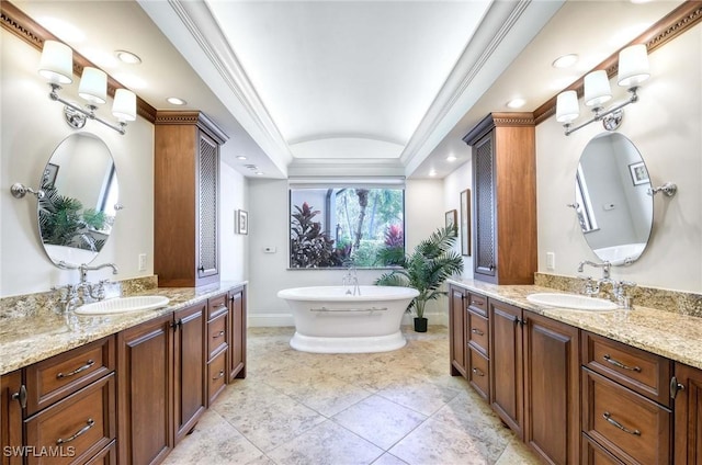 full bath featuring crown molding, two vanities, and a sink