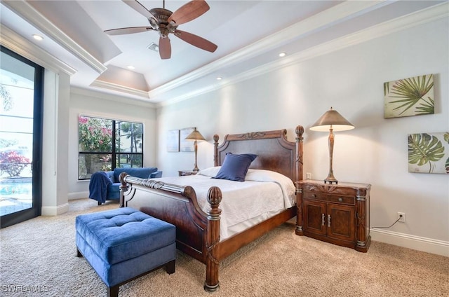 bedroom with baseboards, a raised ceiling, light colored carpet, and ornamental molding