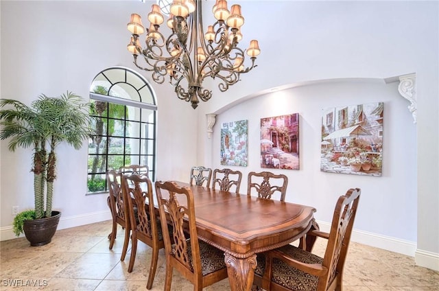 dining area with light tile patterned floors, an inviting chandelier, and baseboards