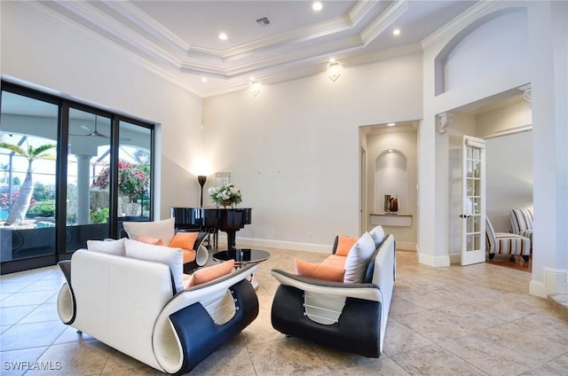 living room featuring visible vents, a raised ceiling, crown molding, and a towering ceiling