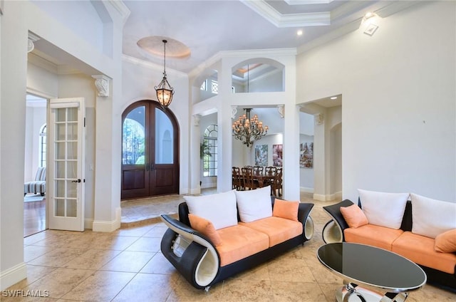 entryway with ornamental molding, french doors, baseboards, and a chandelier