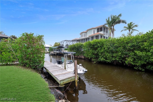 view of dock featuring a water view and a lawn