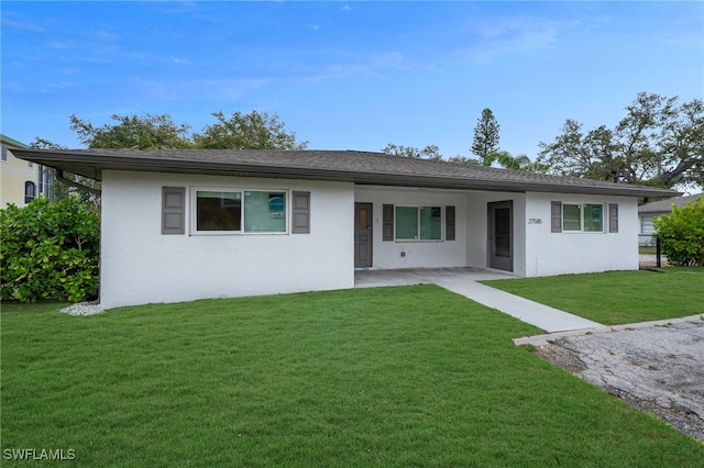 single story home featuring stucco siding and a front yard