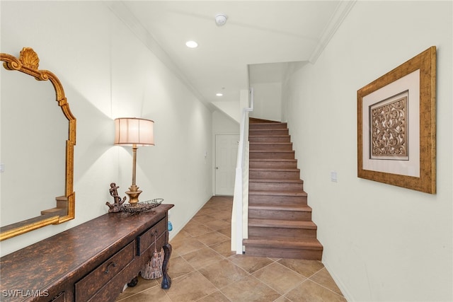 staircase featuring recessed lighting, ornamental molding, and tile patterned flooring