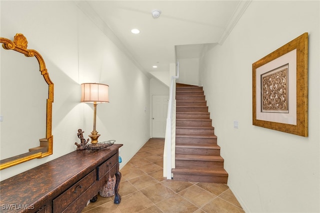 staircase with crown molding, recessed lighting, and tile patterned floors