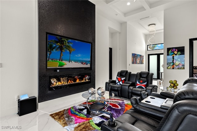 home theater featuring coffered ceiling, a premium fireplace, a towering ceiling, beamed ceiling, and marble finish floor