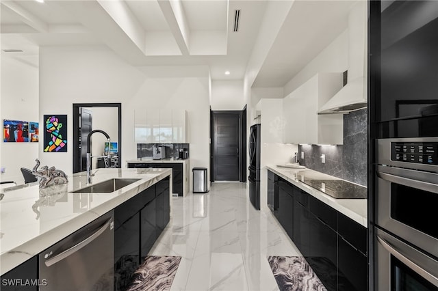 kitchen featuring black appliances, marble finish floor, modern cabinets, a sink, and dark cabinetry