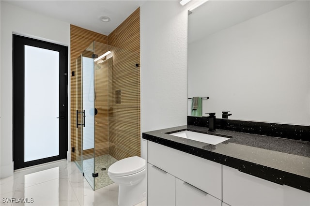 bathroom featuring a stall shower, toilet, and vanity