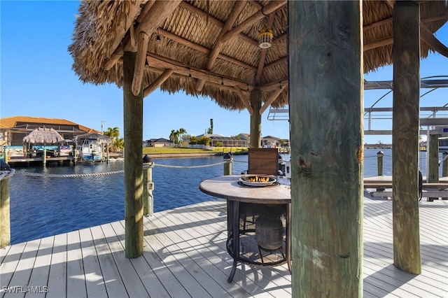 view of dock featuring a gazebo and a water view