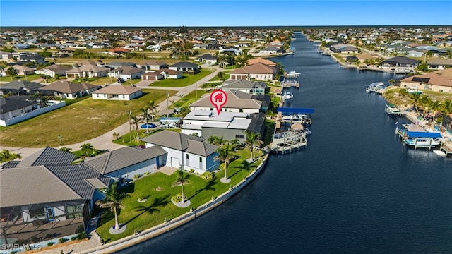 bird's eye view featuring a residential view and a water view