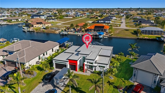 birds eye view of property with a residential view and a water view