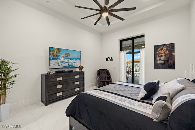 3303 NW 14th St, Cape Coral, FL 33993 - bedroom with a ceiling fan, baseboards, marble finish floor, access to outside, and a raised ceiling