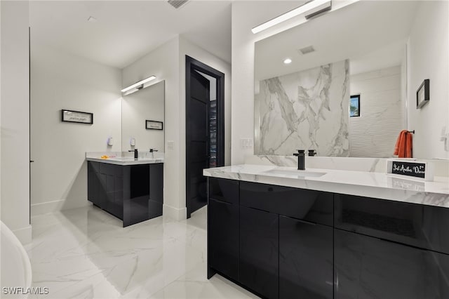 full bathroom with baseboards, two vanities, recessed lighting, a sink, and marble finish floor