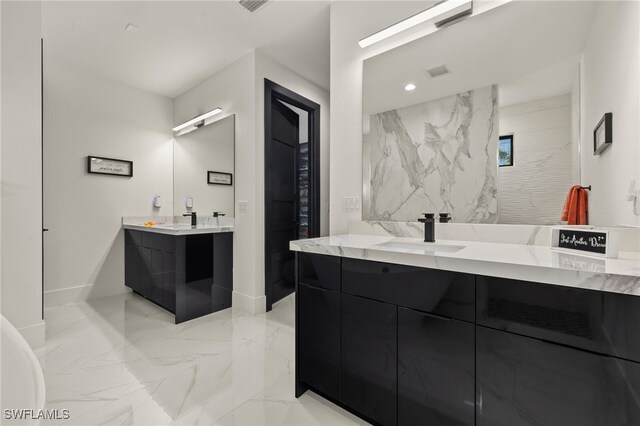 3303 NW 14th St, Cape Coral, FL 33993 - full bath with a sink, two vanities, baseboards, and marble finish floor