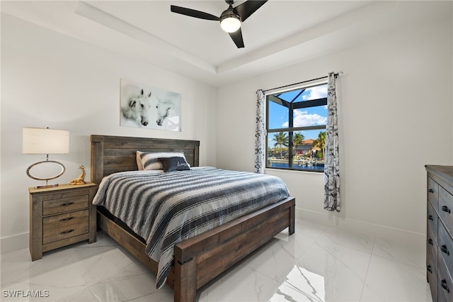 bedroom featuring marble finish floor, a raised ceiling, baseboards, and ceiling fan