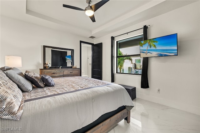 bedroom featuring visible vents, a raised ceiling, marble finish floor, and baseboards