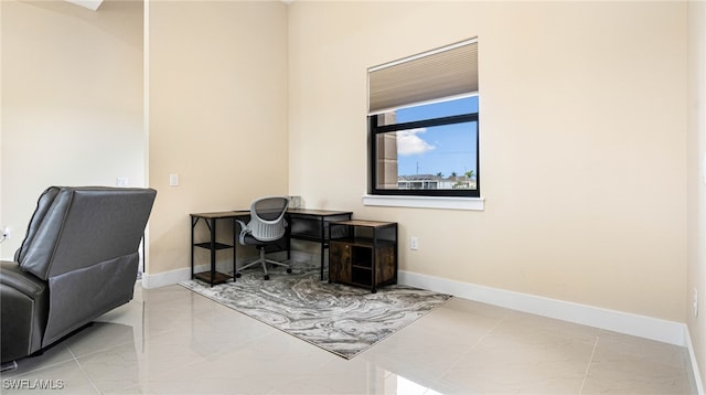 office area featuring marble finish floor and baseboards