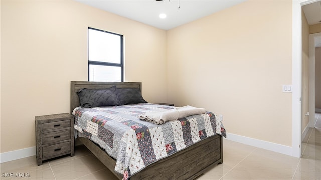 bedroom with light tile patterned floors, baseboards, and a ceiling fan