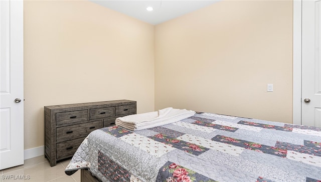 bedroom featuring light tile patterned floors and baseboards